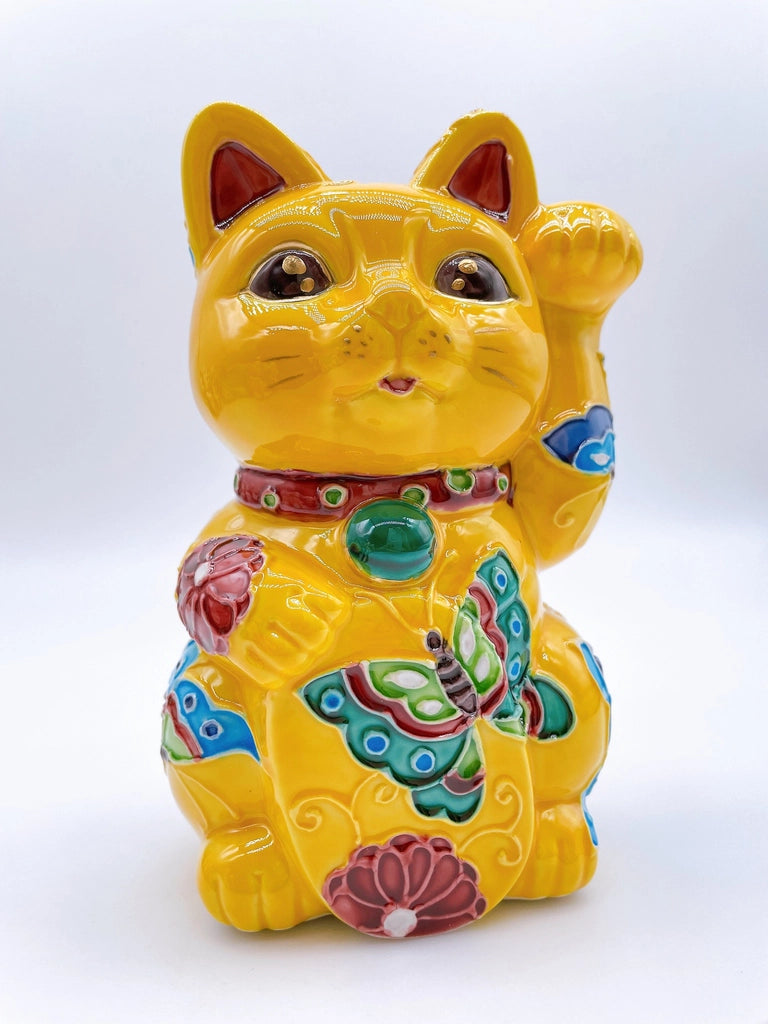 Japanese Kiyomizu-style lucky cat saucer with a yellow background and floral design.