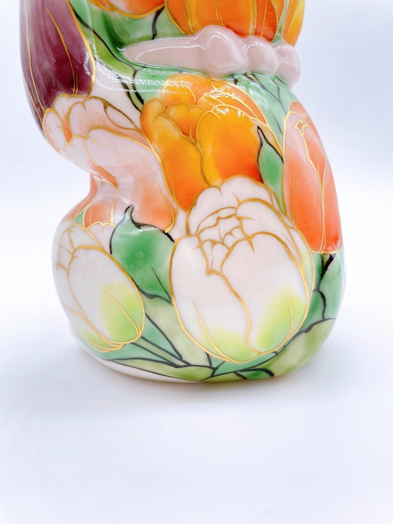 Japanese Kiyomizu-style lucky cat with white tulip background