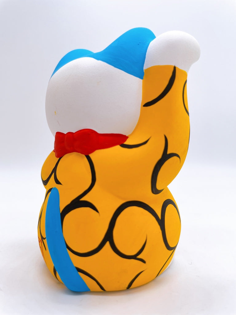Japanese arabesque yellow lucky cat with a million taels of silver