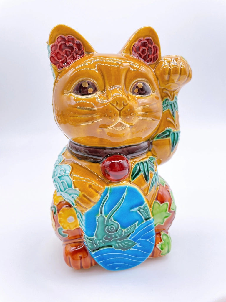 Japanese Kiyomizu-style lucky cat with a yellowish-brown base.