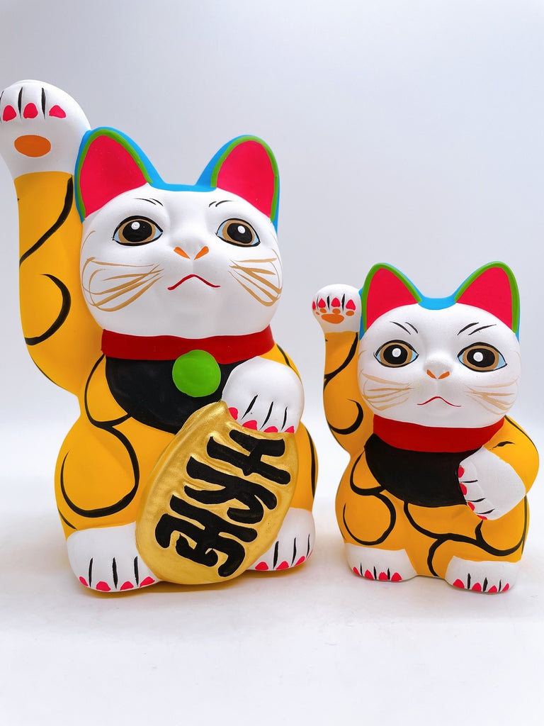 Japanese arabesque yellow lucky cat with a million taels of silver