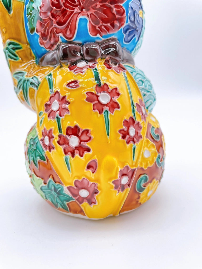 Japanese Kiyomizu-style lucky cat with a yellowish-brown base.