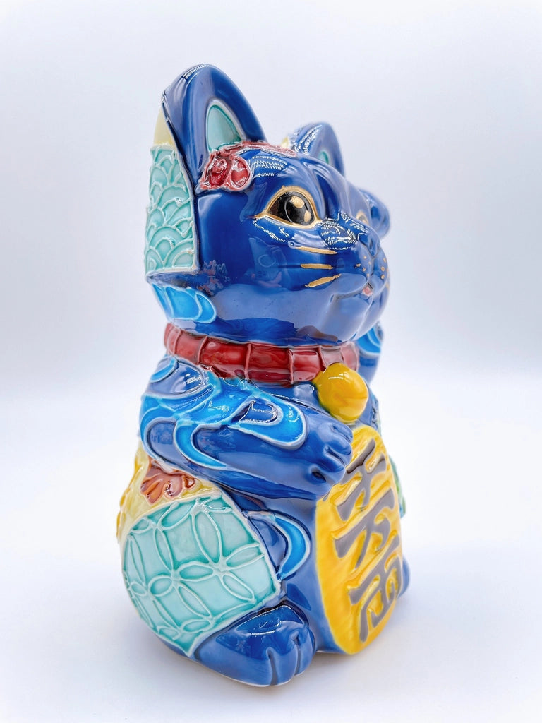 Japanese Kiyomizu-style Maneki-neko (lucky cat) with cross-colored dark blue background and floral pattern.