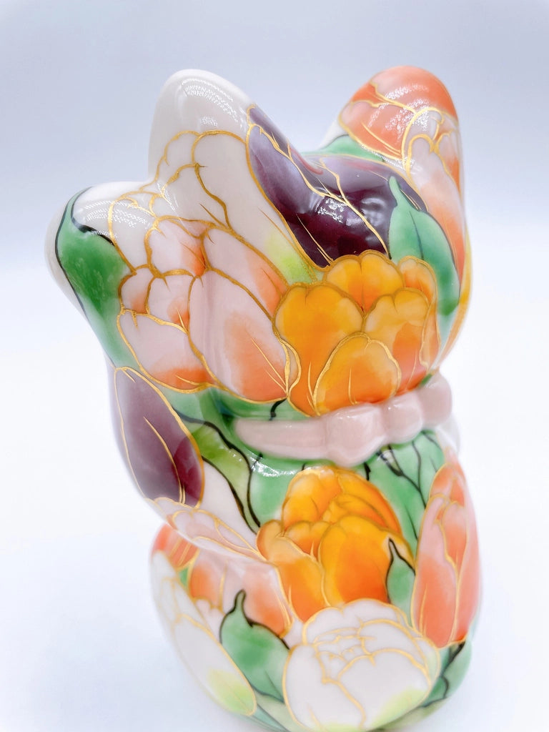 Japanese Kiyomizu-style lucky cat with white tulip background