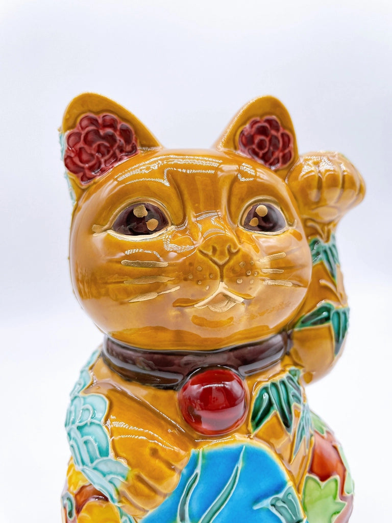 Japanese Kiyomizu-style lucky cat with a yellowish-brown base.