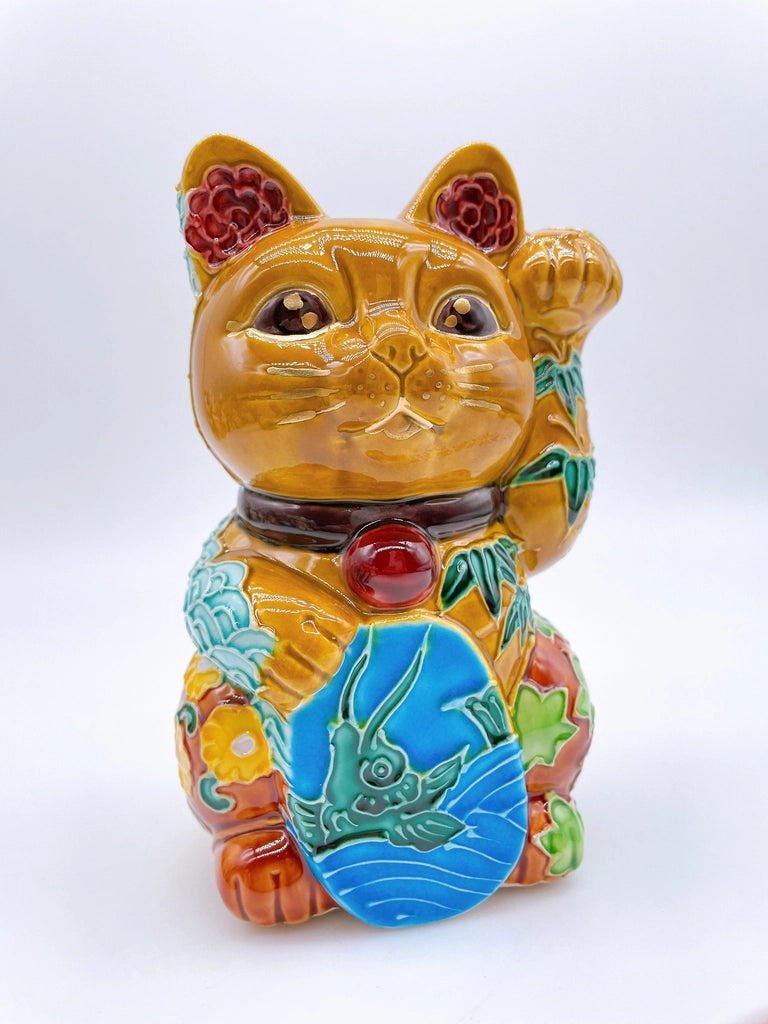 Japanese Kiyomizu-style lucky cat with a yellowish-brown base.