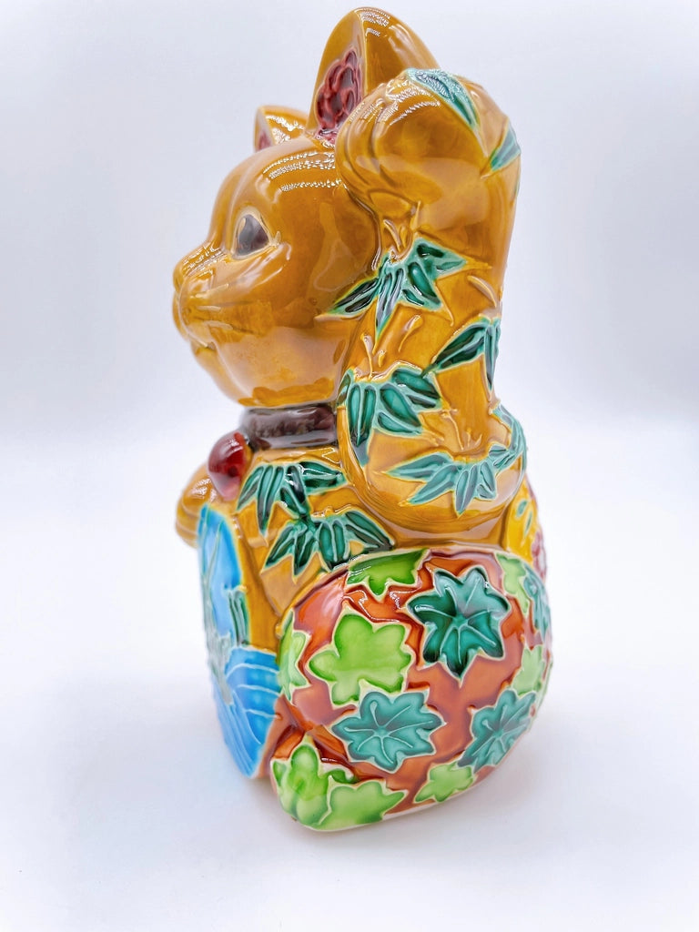 Japanese Kiyomizu-style lucky cat with a yellowish-brown base.