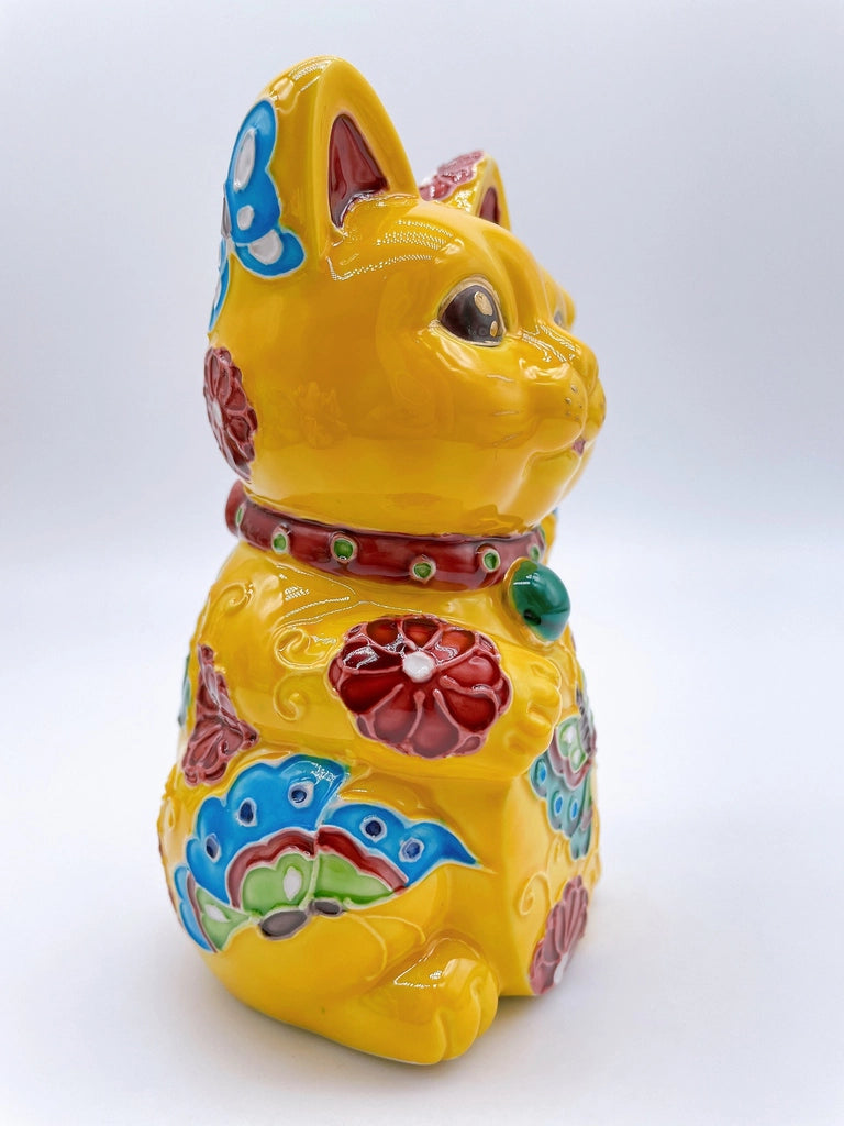 Japanese Kiyomizu-style lucky cat saucer with a yellow background and floral design.