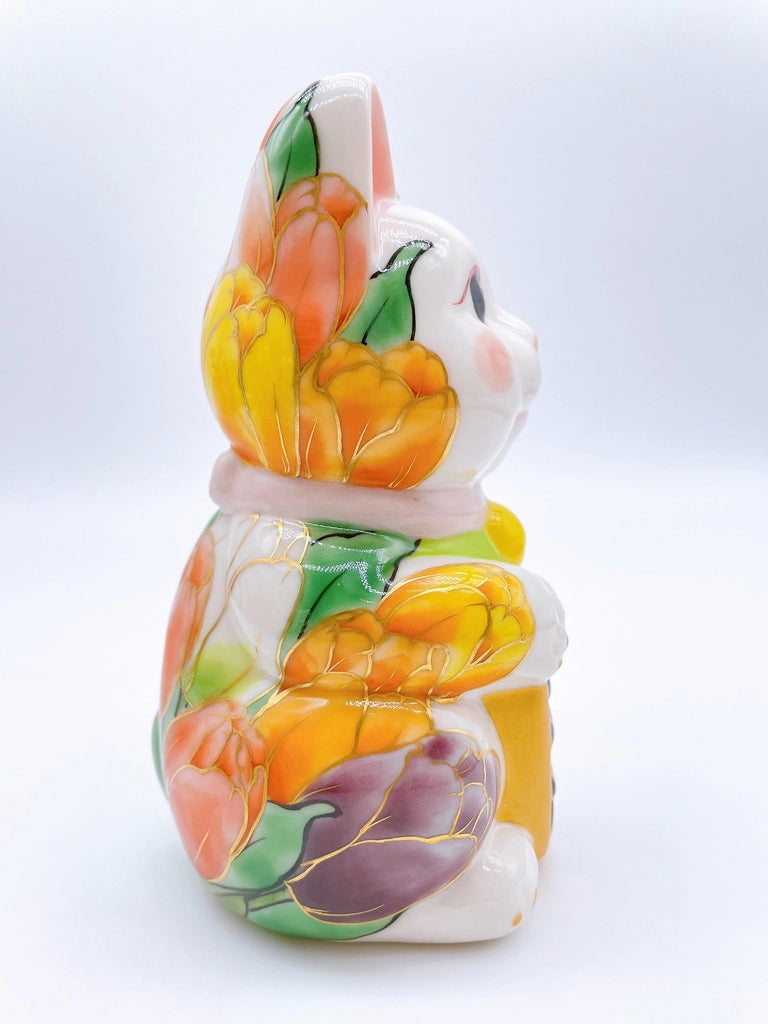 Japanese Kiyomizu-style lucky cat with white tulip background