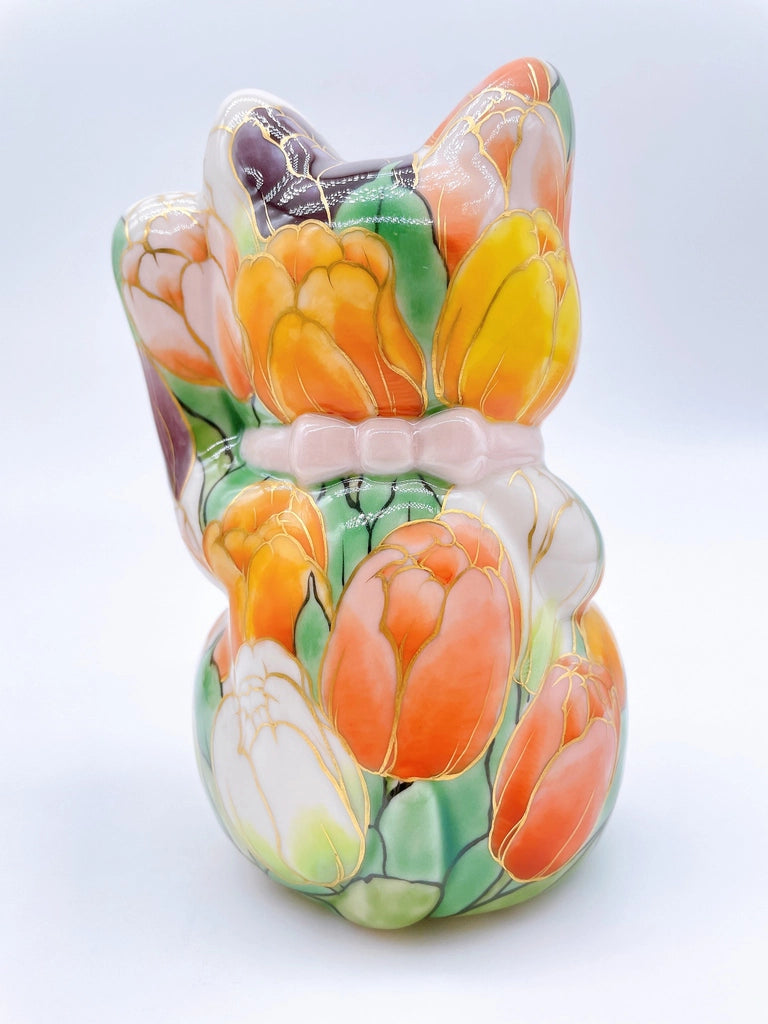 Japanese Kiyomizu-style lucky cat with white tulip background