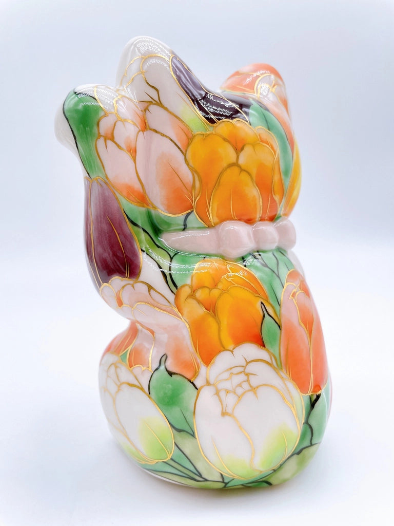 Japanese Kiyomizu-style lucky cat with white tulip background