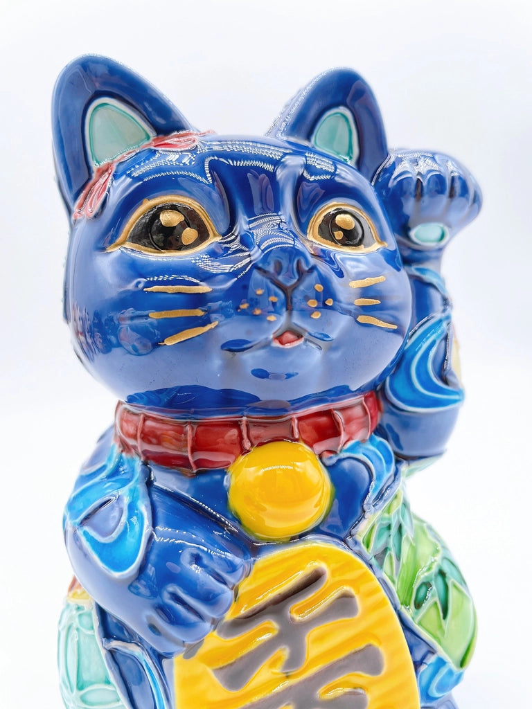 Japanese Kiyomizu-style Maneki-neko (lucky cat) with cross-colored dark blue background and floral pattern.