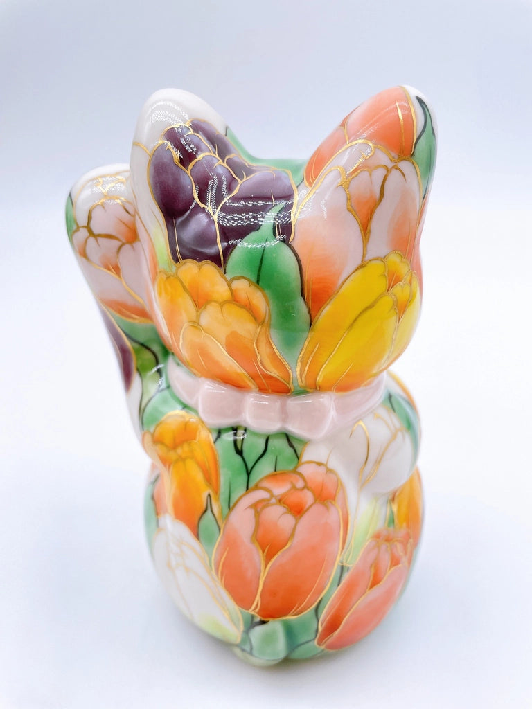 Japanese Kiyomizu-style lucky cat with white tulip background
