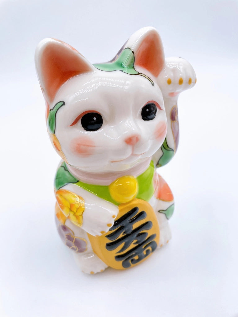 Japanese Kiyomizu-style lucky cat with white tulip background