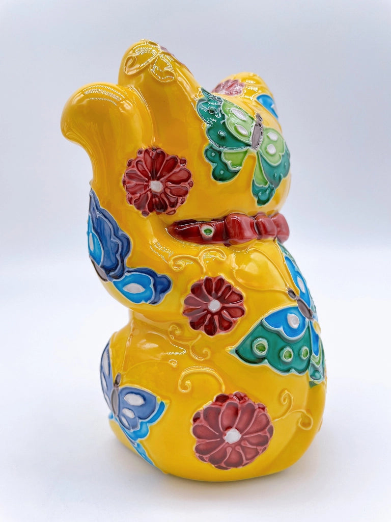Japanese Kiyomizu-style lucky cat saucer with a yellow background and floral design.