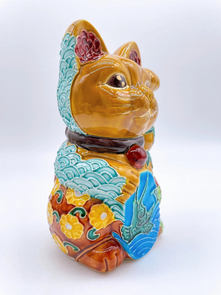 Japanese Kiyomizu-style lucky cat with a yellowish-brown base.