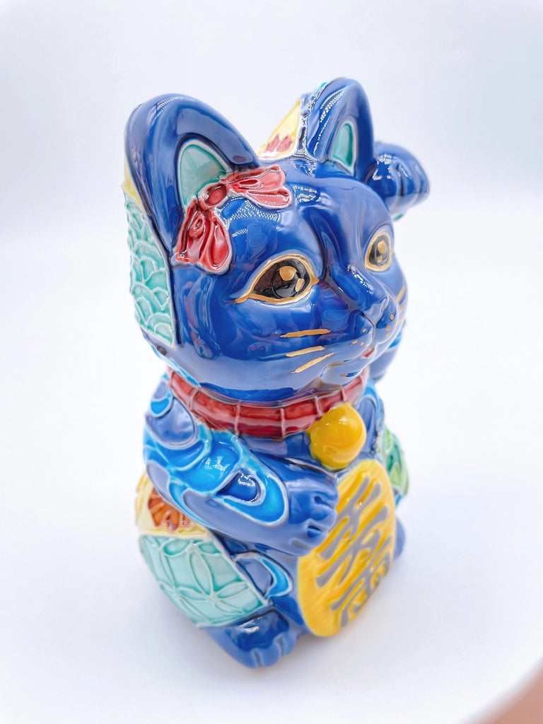 Japanese Kiyomizu-style Maneki-neko (lucky cat) with cross-colored dark blue background and floral pattern.