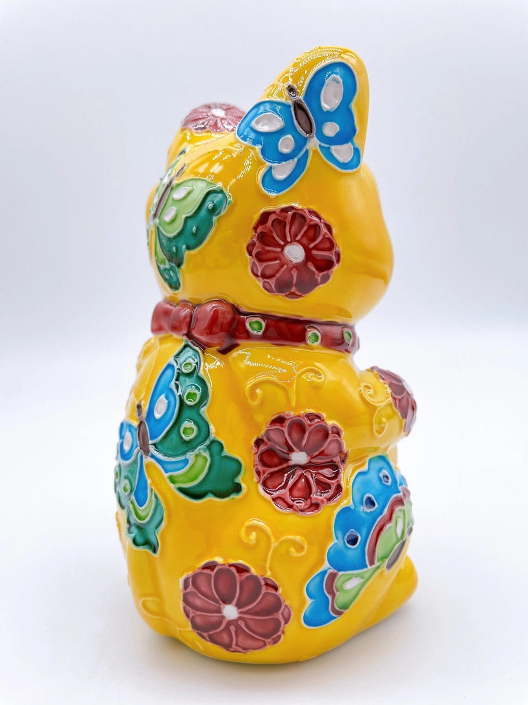 Japanese Kiyomizu-style lucky cat saucer with a yellow background and floral design.